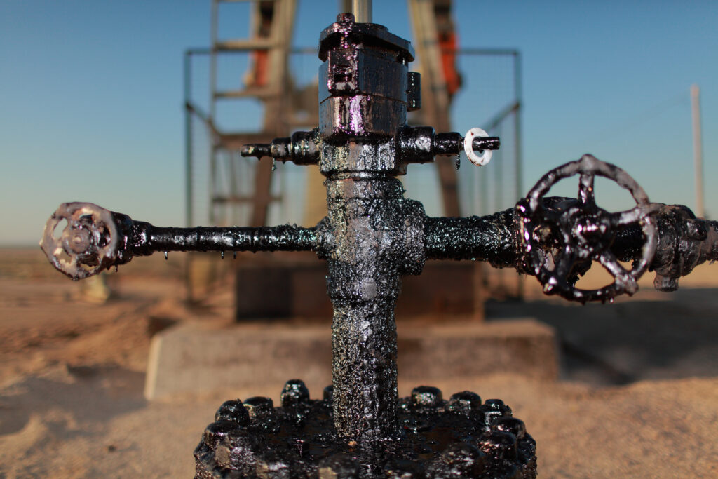 close up of grimy pipes at oil field