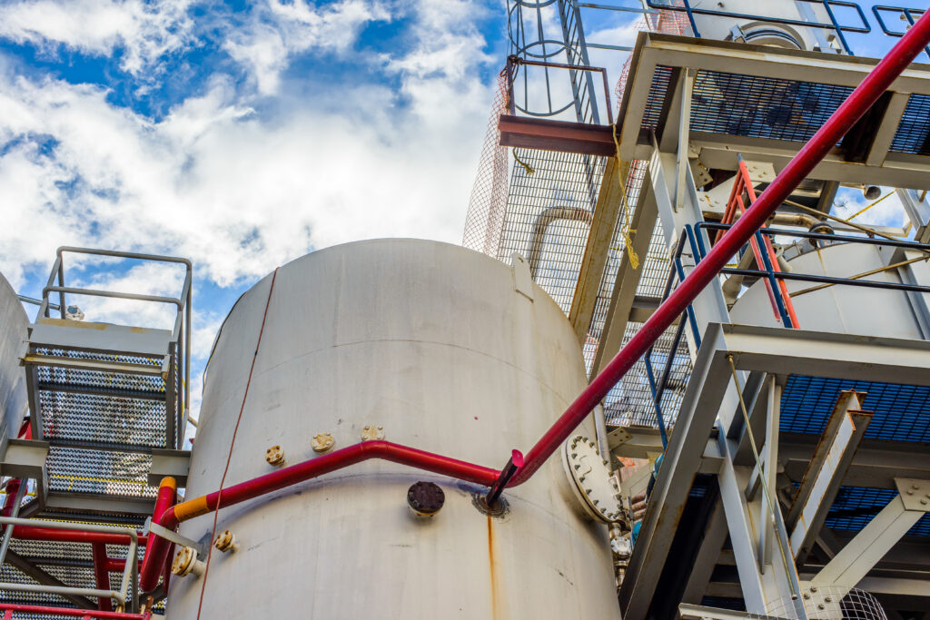 low angle view of storage tanks and industrial piping at biofuel plant