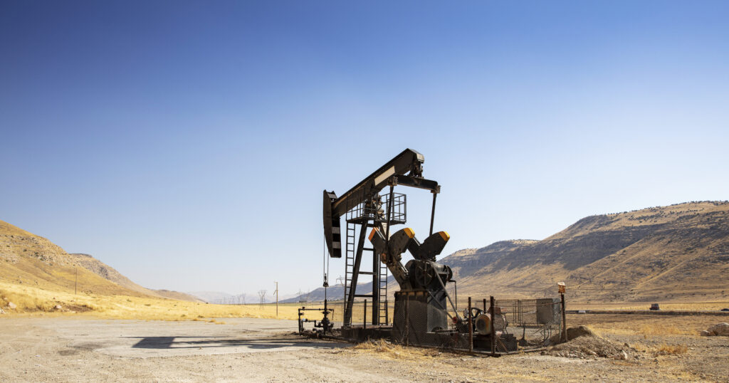 oil drilling derricks at desert oilfield. crude oil production from the ground. petroleum production