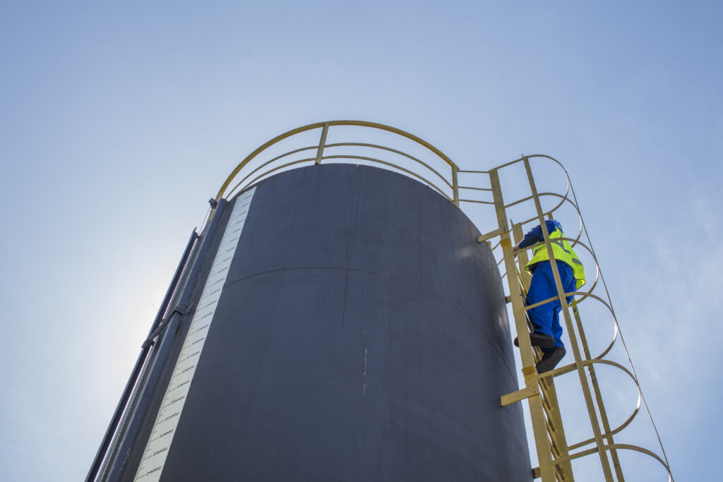 construction worker climbing up ladder
