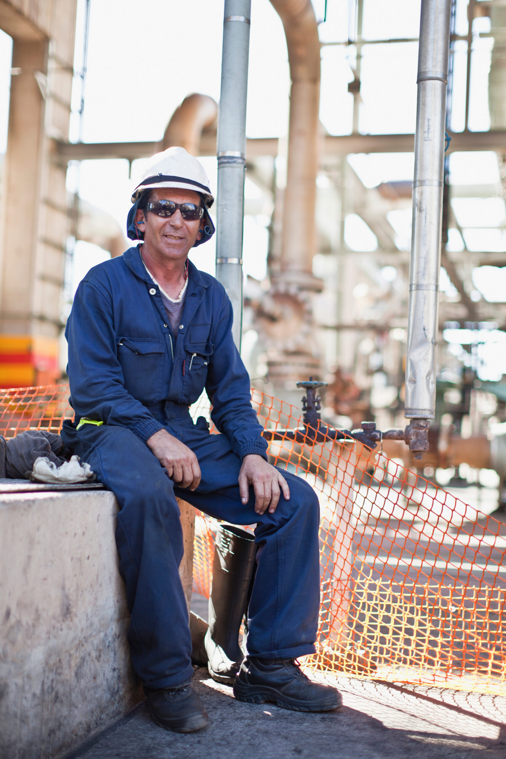 worker sitting at oil refinery